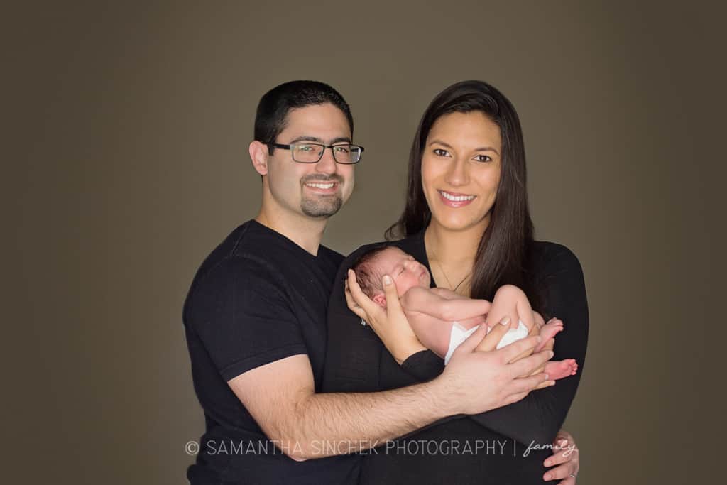 mother and father hold newborn son