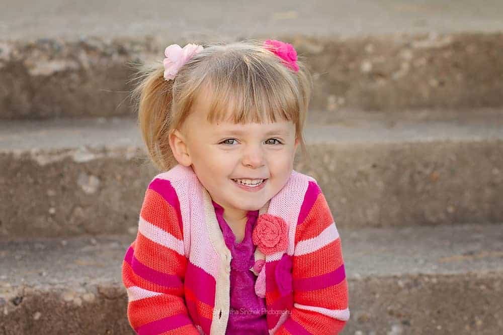 Adorable girl smiles at the camera