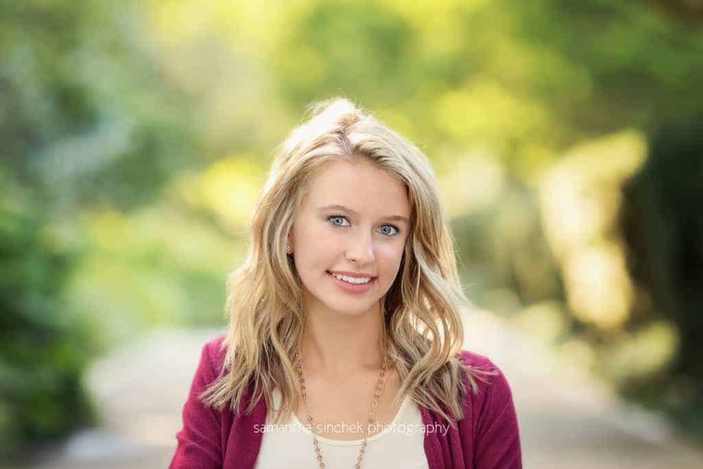 head shot of senior girl on path at ault park