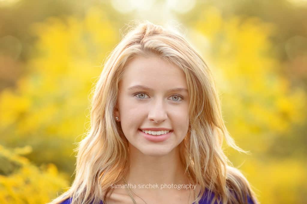 head shot of kings high school senior against beautiful yellow flowers
