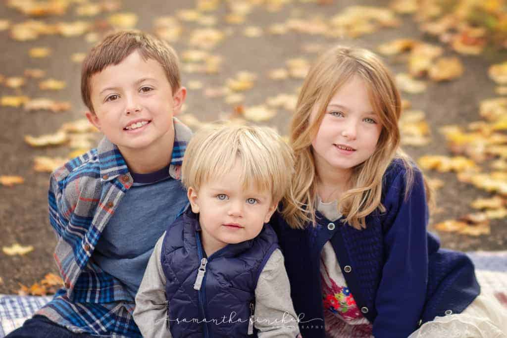 siblings sit on path 