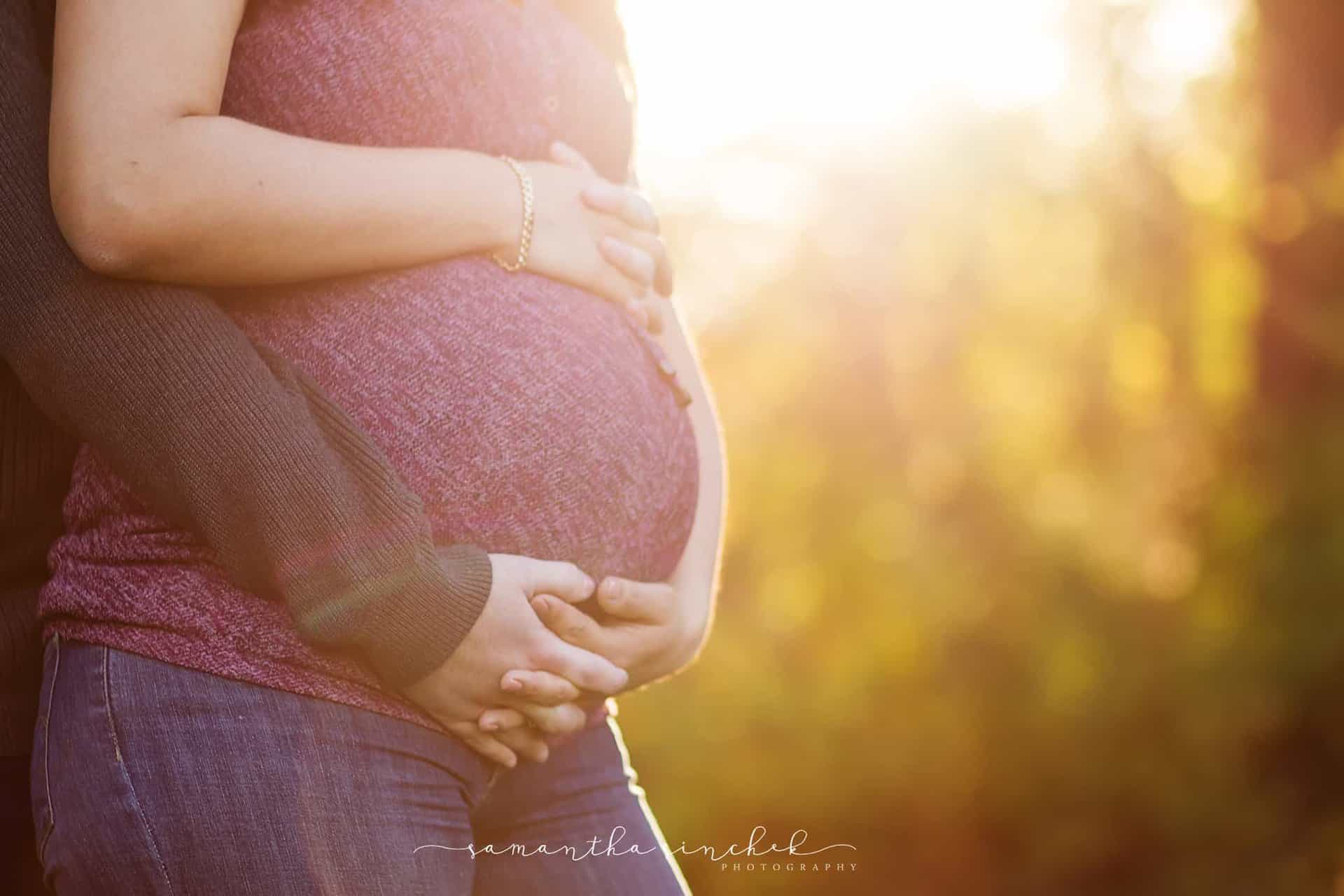 Maternity photo framed with sunlight at Sharon woods