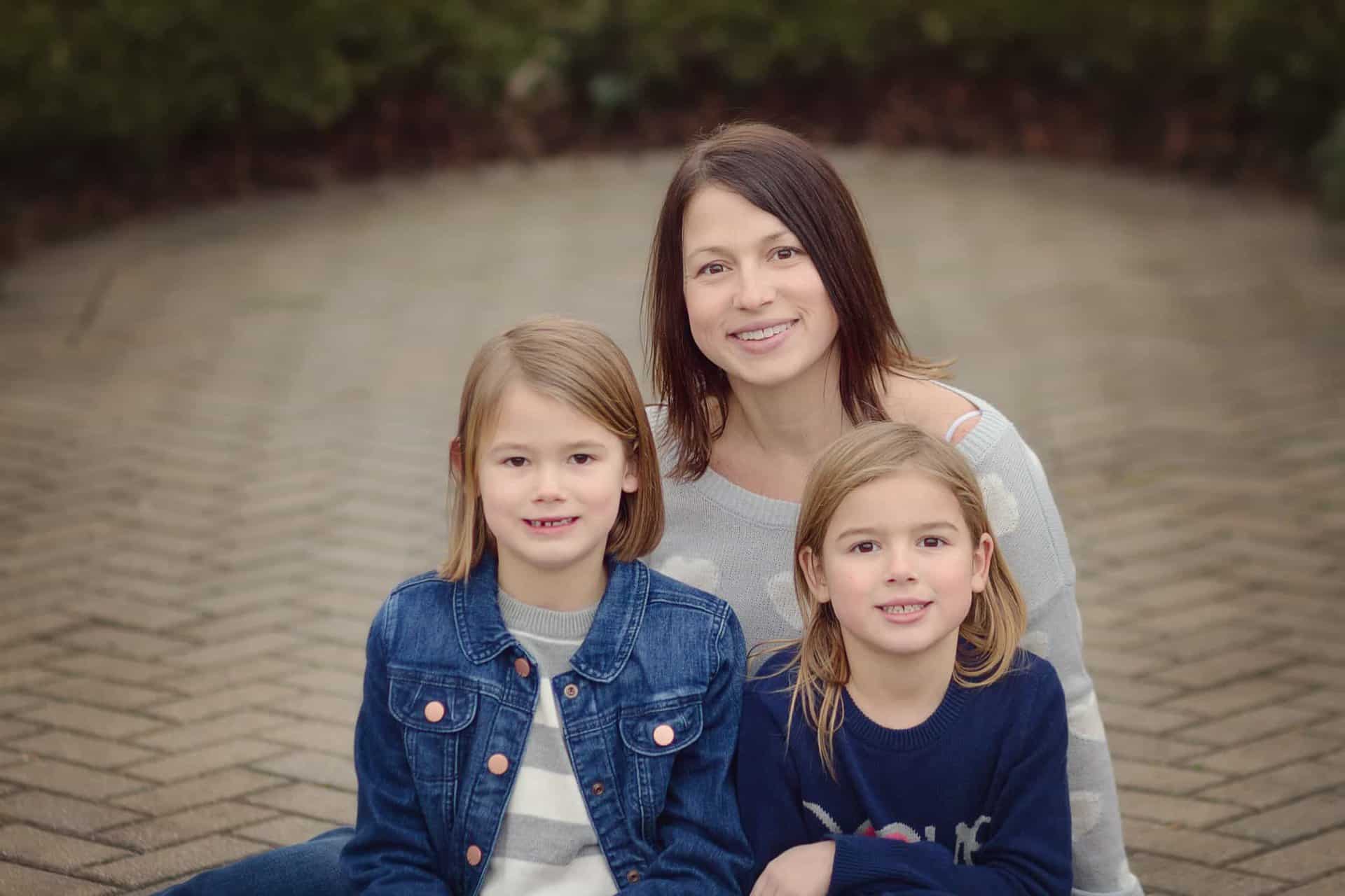 Mother sits with two daughters at Ault park