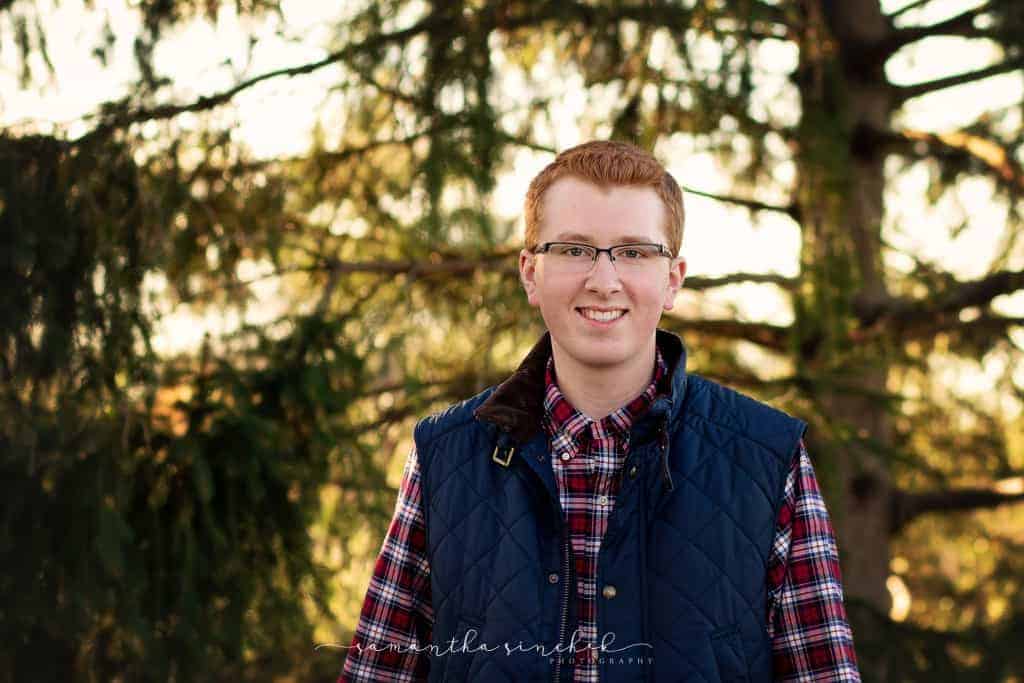 lakota west senior wears vest during session with samantha sinchek photography