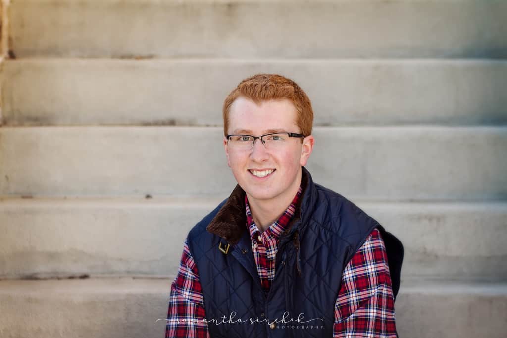 lakota west senior wears vest during session with samantha sinchek photography