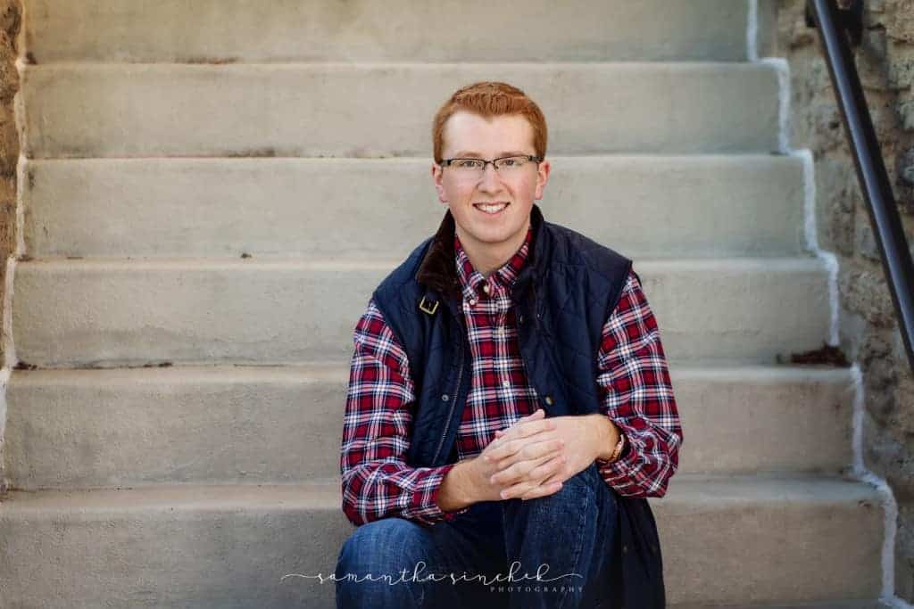 lakota west senior wears vest during session with samantha sinchek photography
