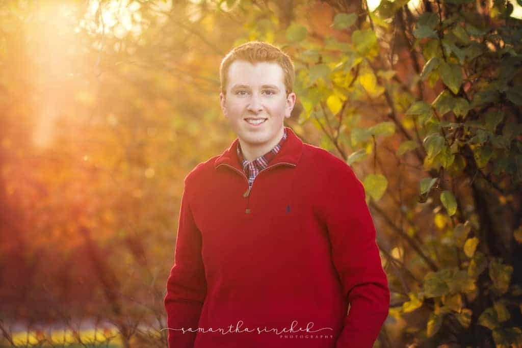 cincinnati senior boy stands bathed in warm sunlight
