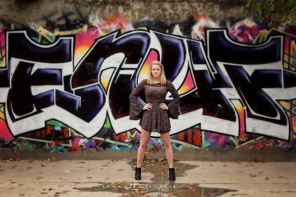 Mason Ohio senior stands with hands on hips in front of cool graffiti