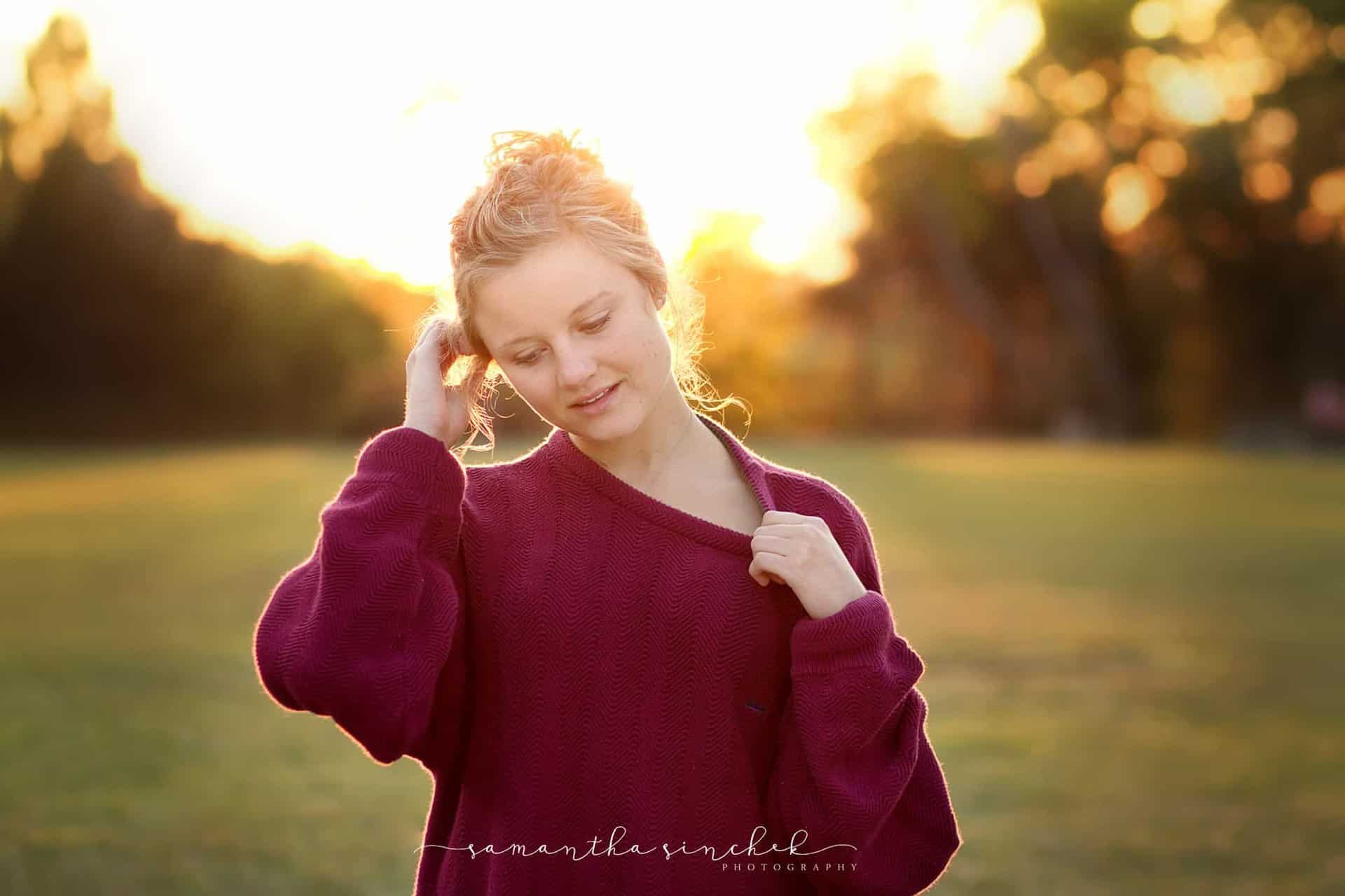 backlit photo at ault park of girl wearing sweater