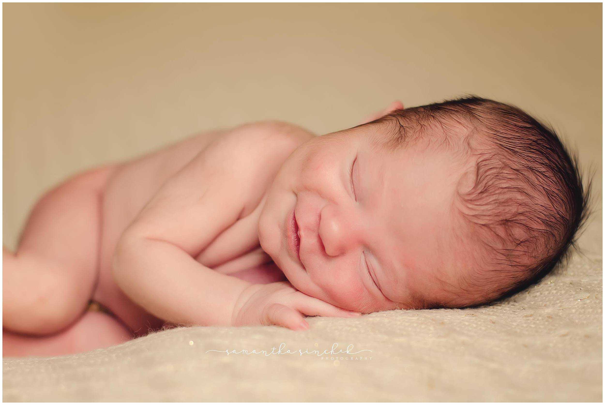 best cincinnati newborn photographer captures sleeping newborn at her reading home