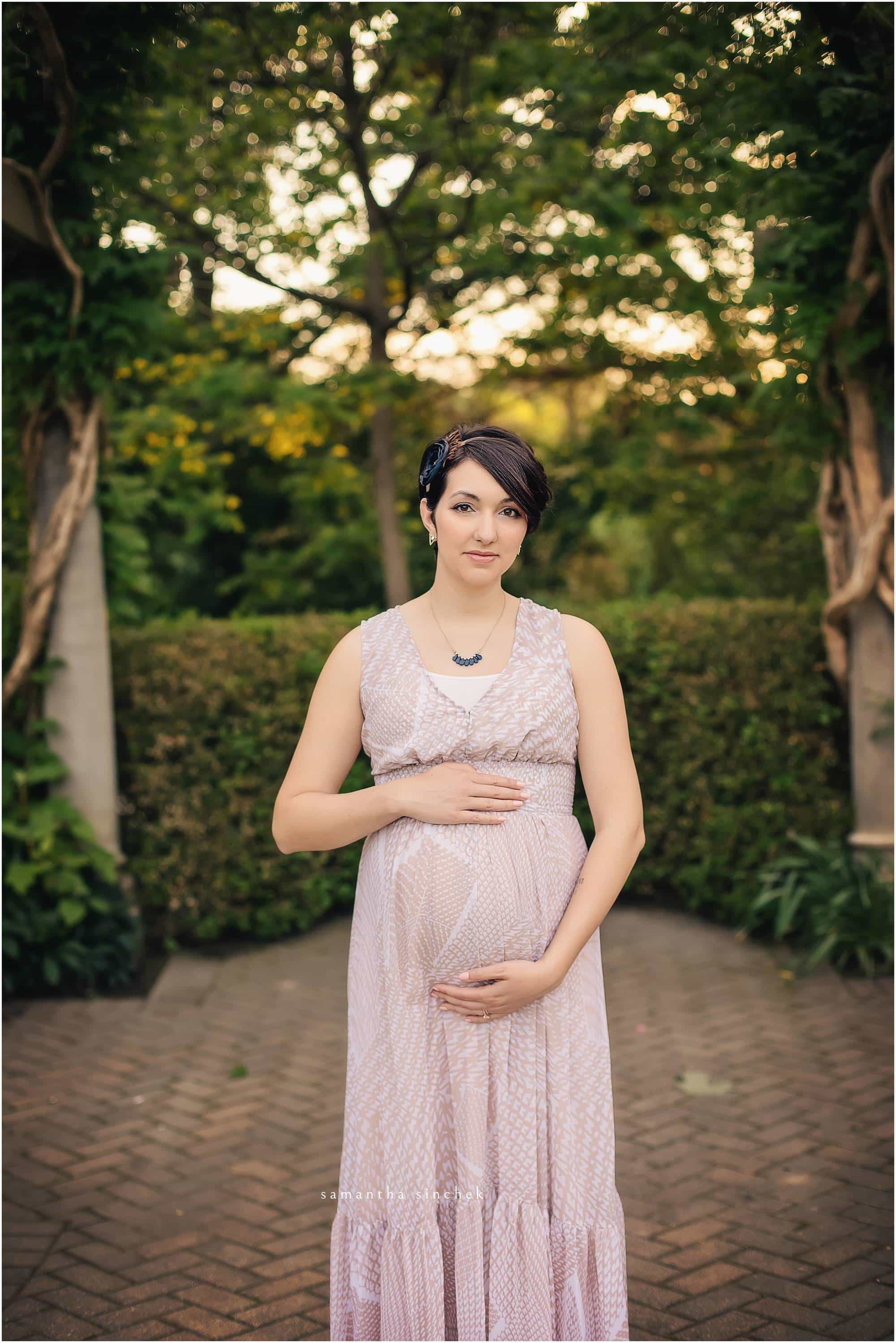 mother to be holds stomach at maternity session with sinchek photography in cincinnati ohio