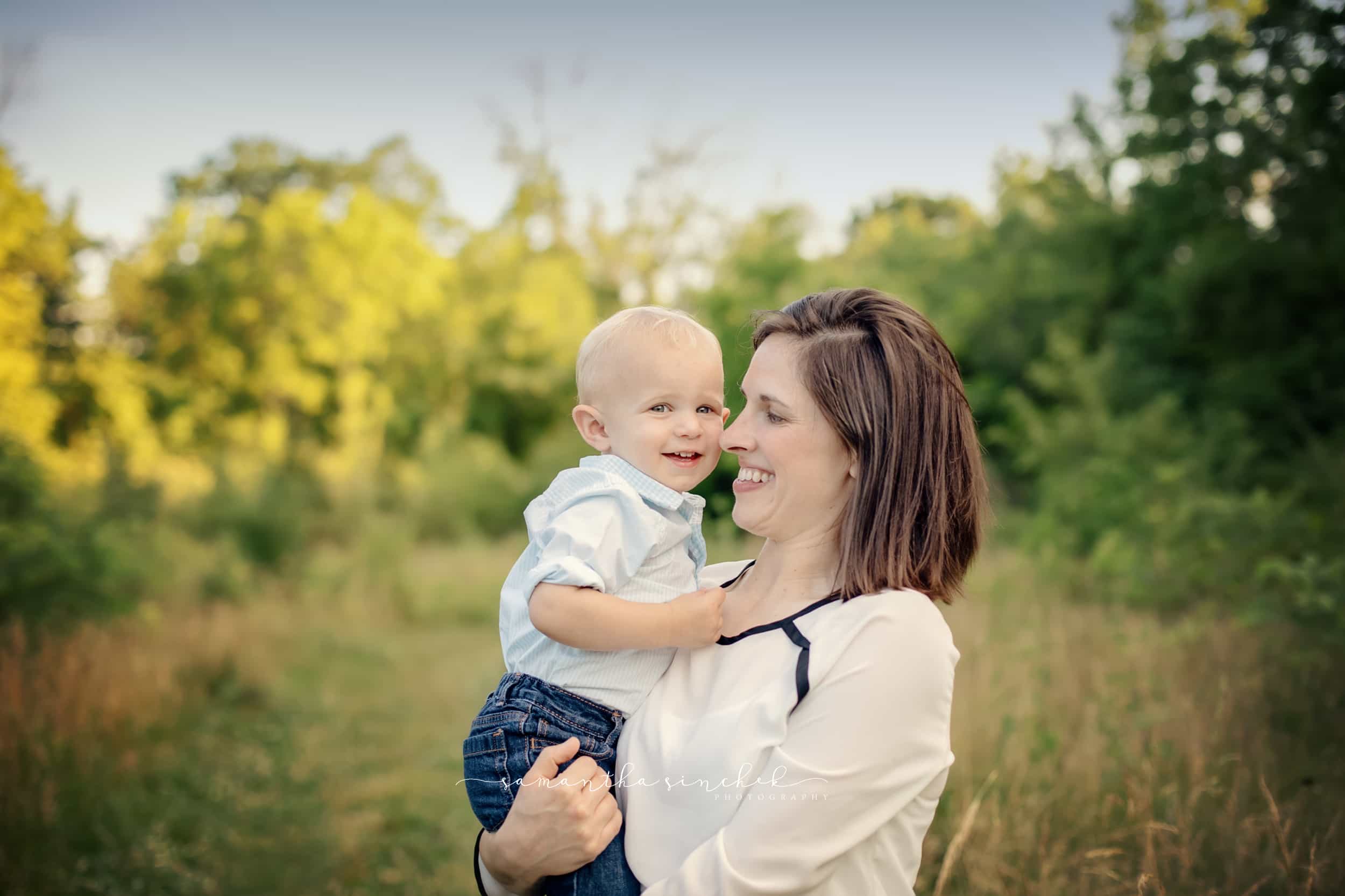 mother holds baby during family pictures at sharon woods with samantha sinchek 