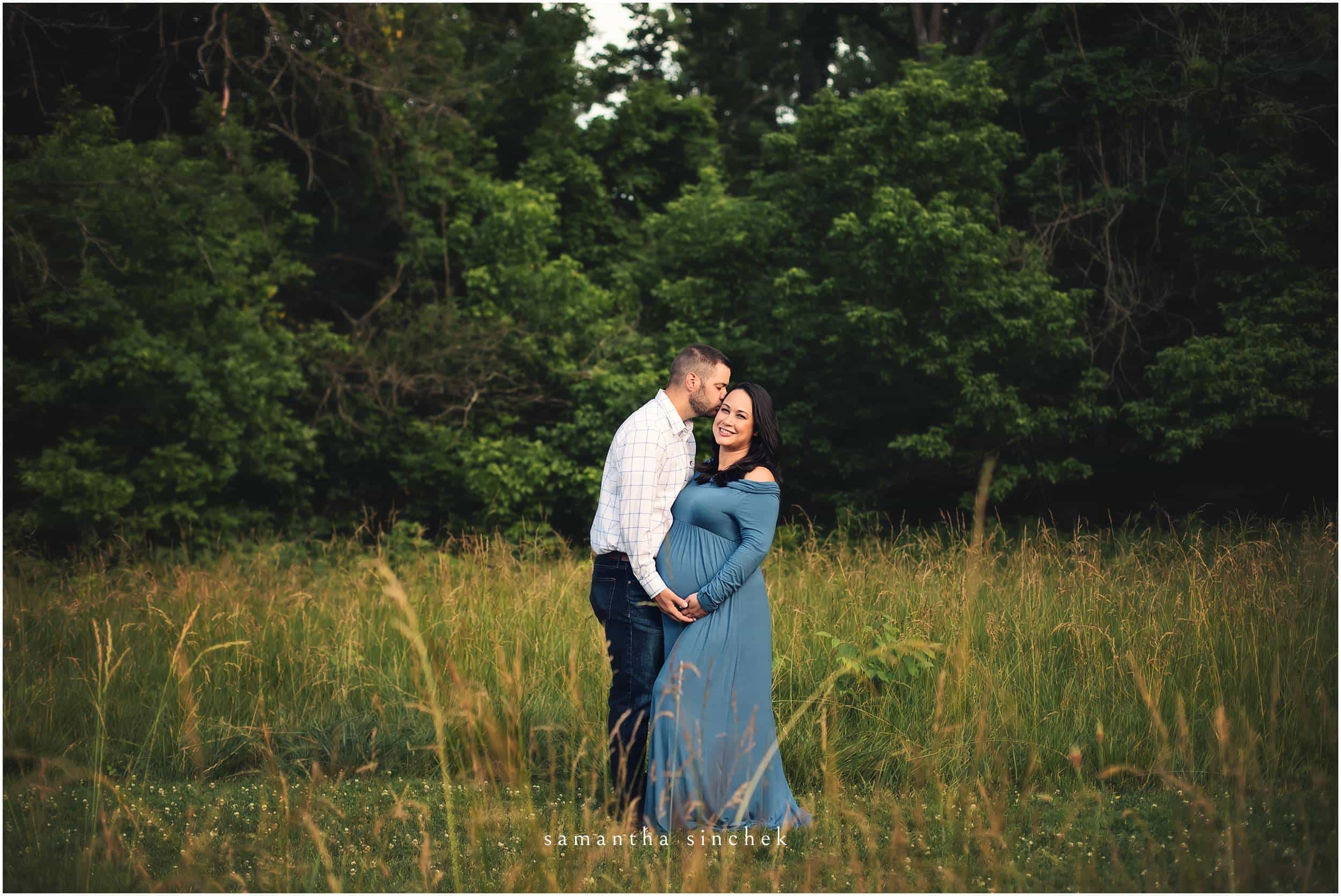 father kisses mother on the head at sharon woods in cincinnati ohio with samantha sinchek photography
