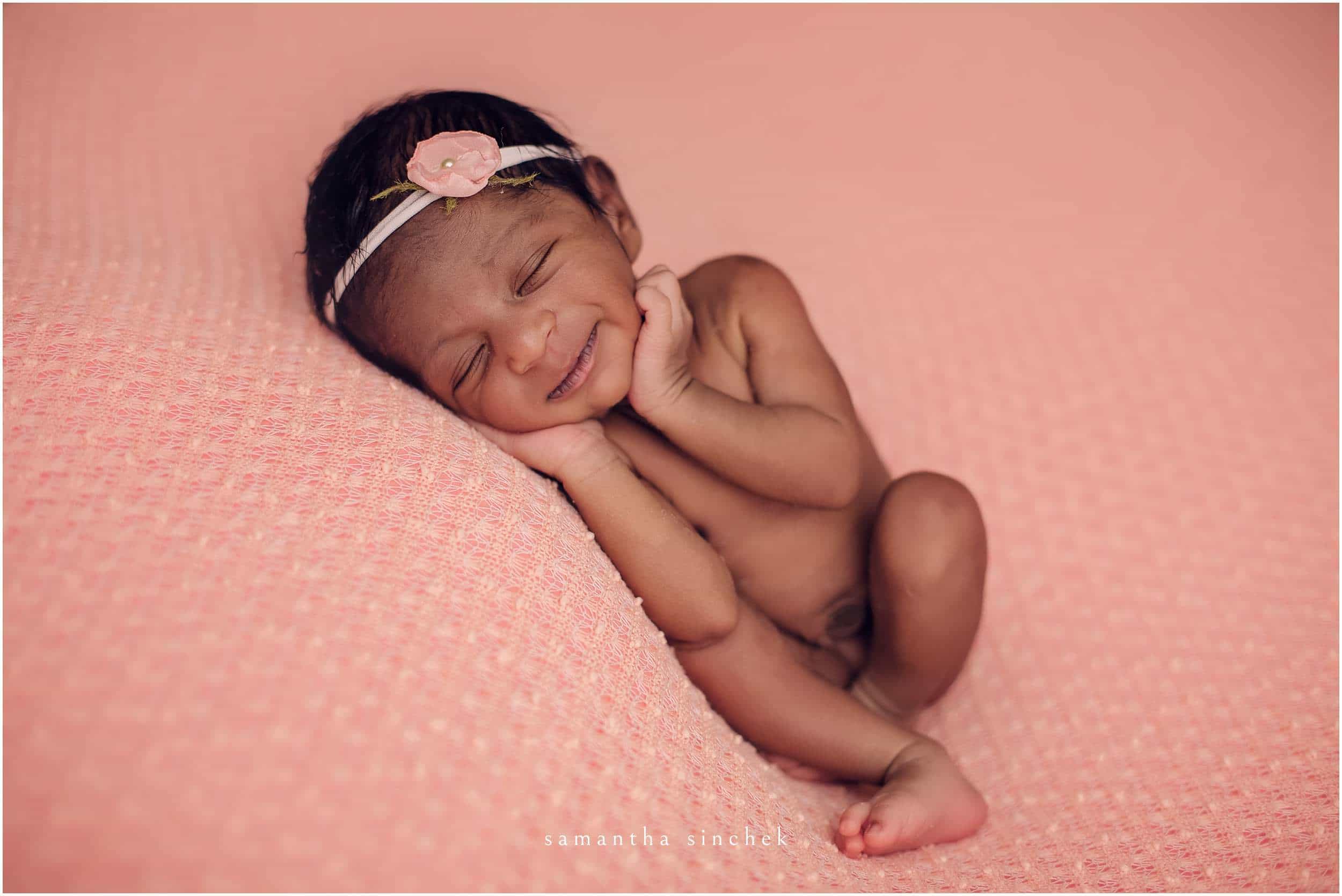 newborn girl smiles at newborn pictures with samantha sinchek photography of CINCINNATI OHIO