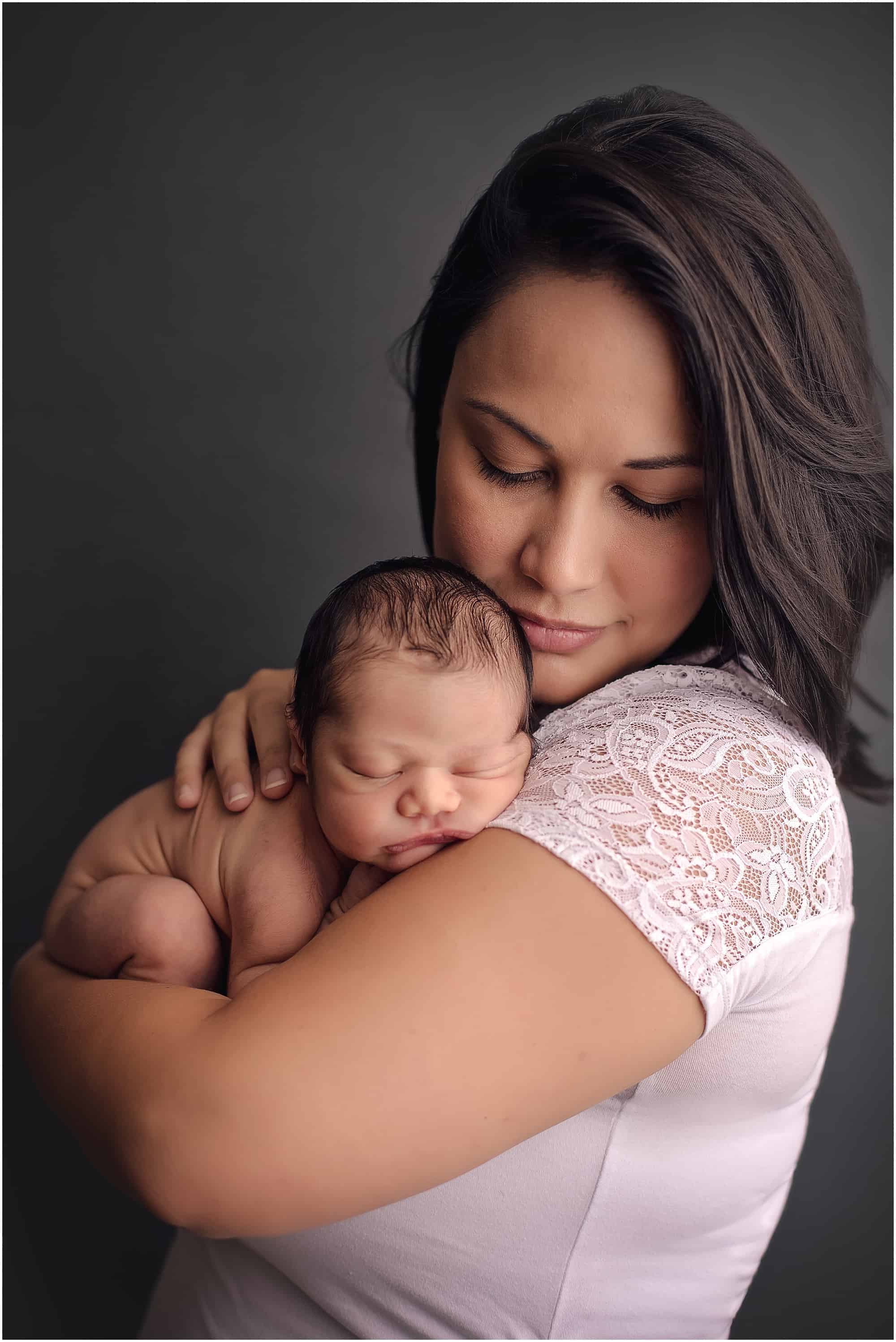 mother holds newborn boy during newborn session with Samantha sinchek photography of Cincinnati Ohio