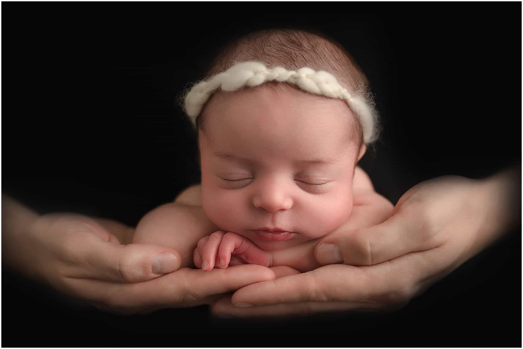 safe in dads hand pose during pictures with Samantha sinchek photography of loveland ohio