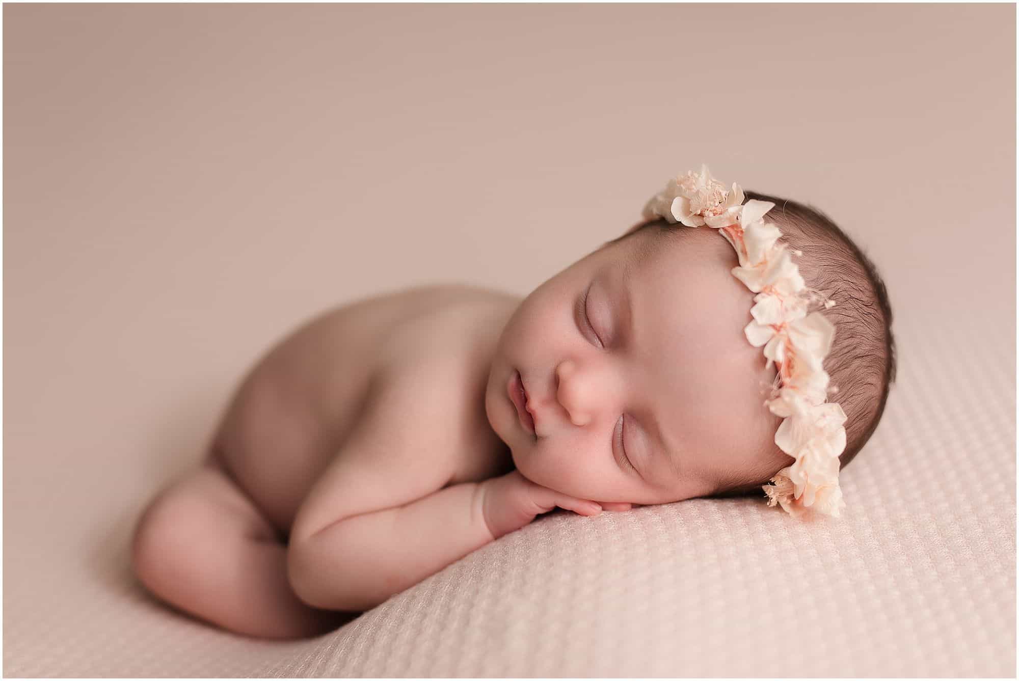 newborn girl sleeps on pink background at pictures with Samantha sinchek photography in cincinnati ohio