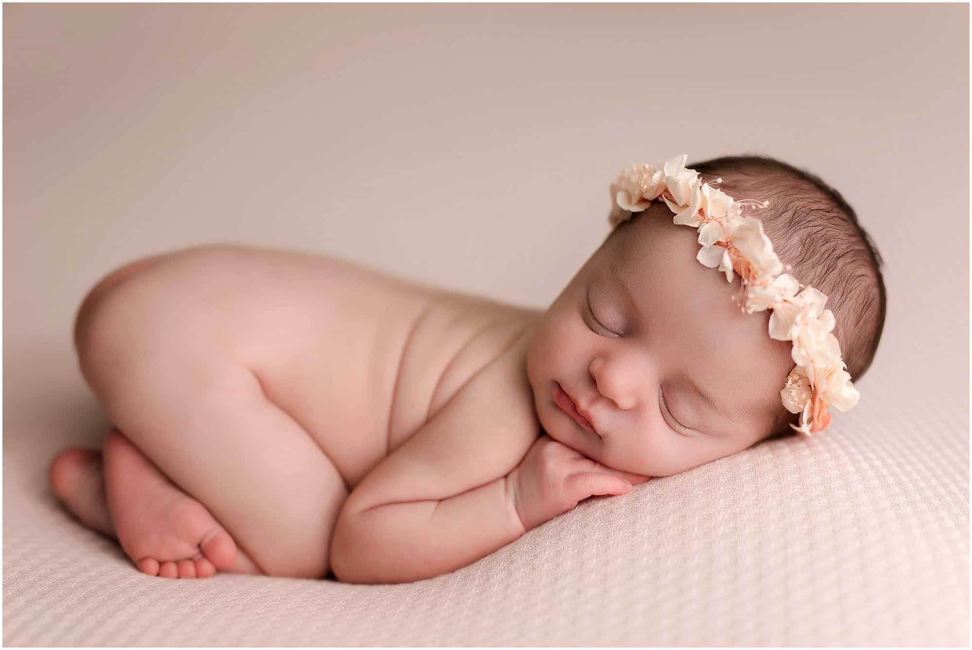 newborn girl sleeps on pink background at pictures with Samantha sinchek photography in cincinnati ohio