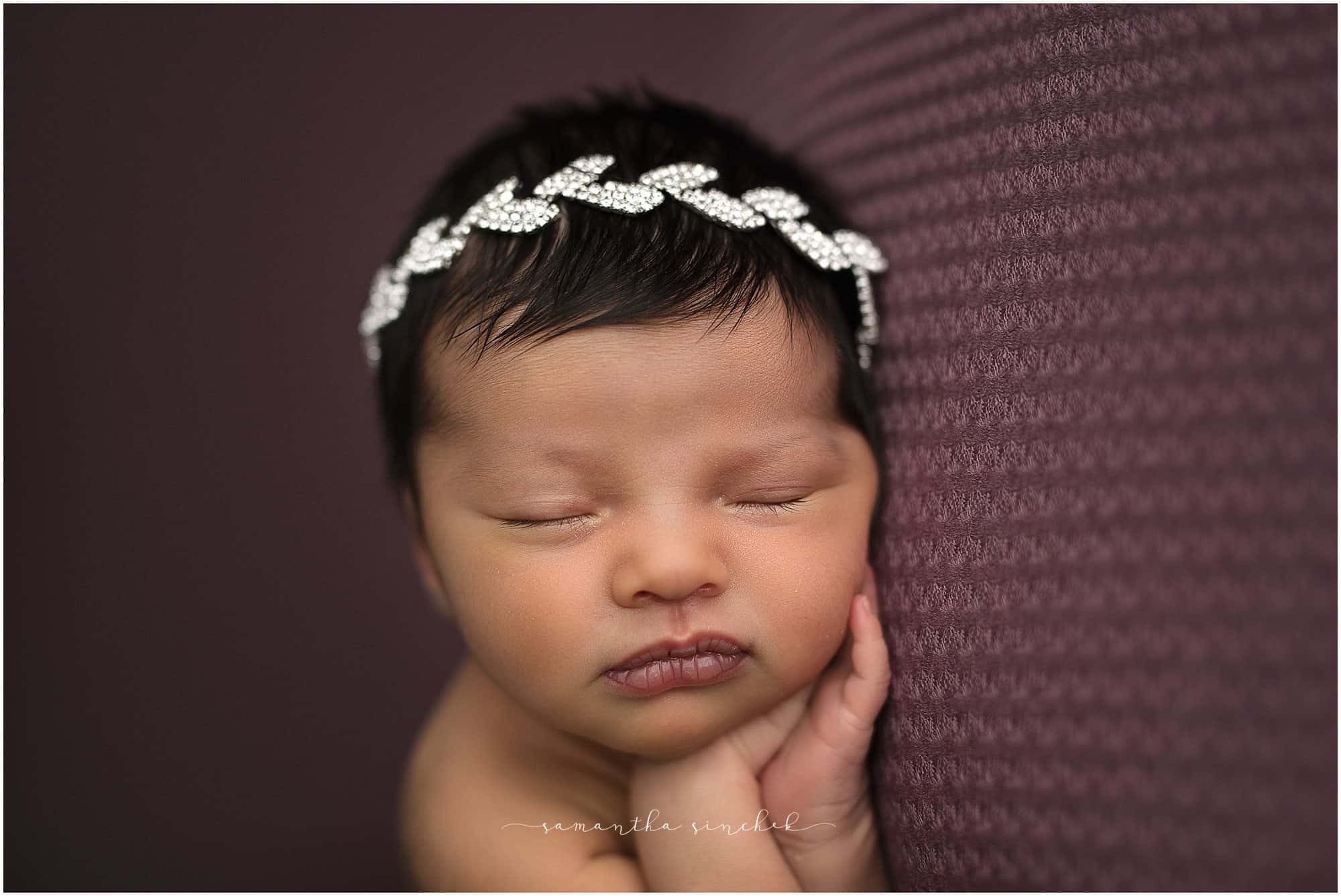 newborn girl sleeps on beautiful purple background with Samantha Sinchek photography of Cincinnati Ohio