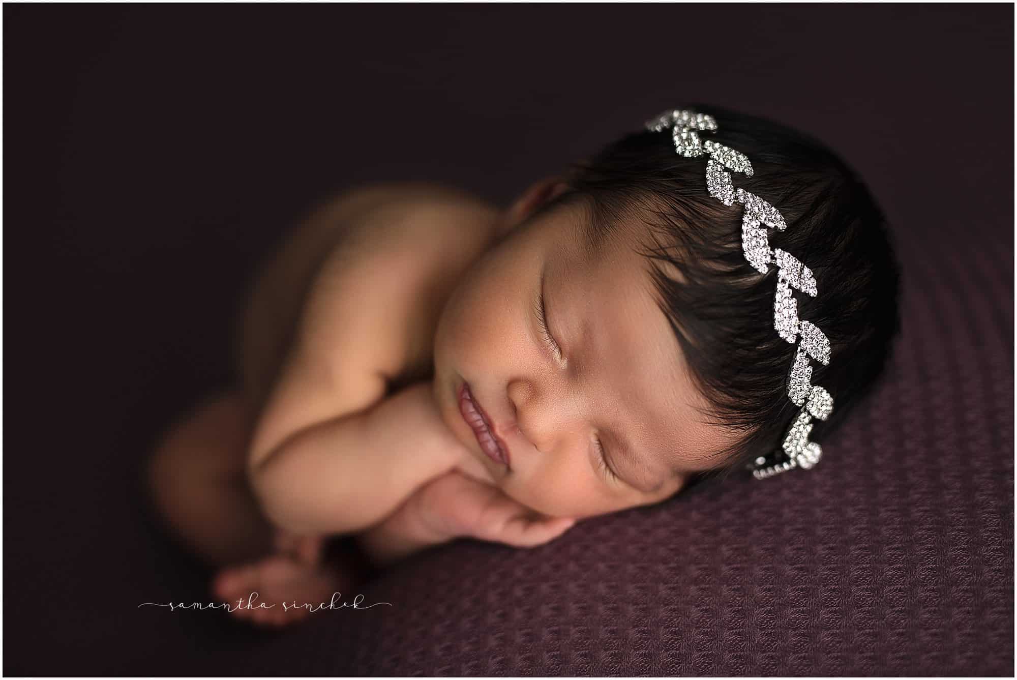 newborn girl sleeps on beautiful purple background with Samantha Sinchek photography of Cincinnati Ohio