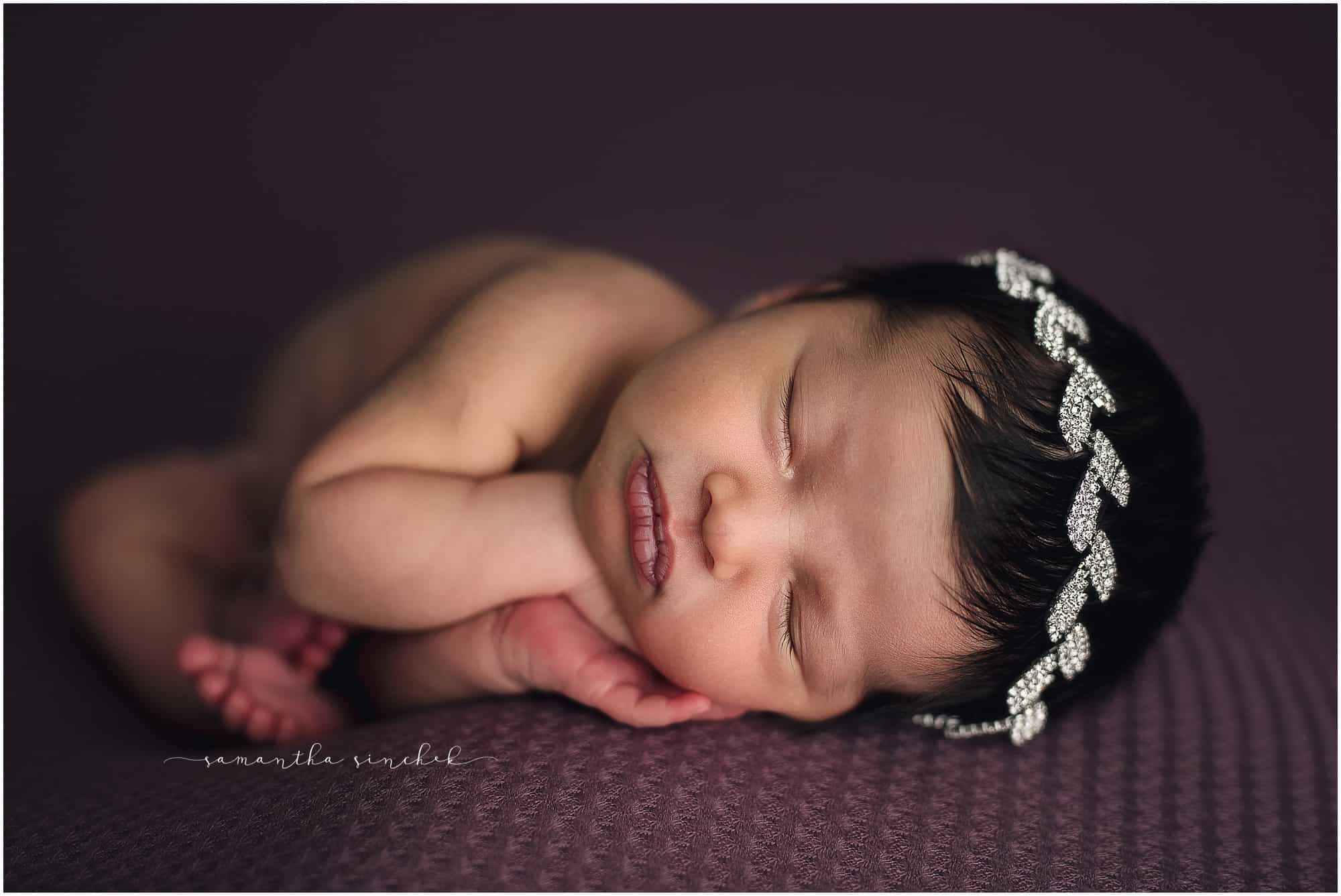 newborn girl sleeps on beautiful purple background with Samantha Sinchek photography of Cincinnati Ohio
