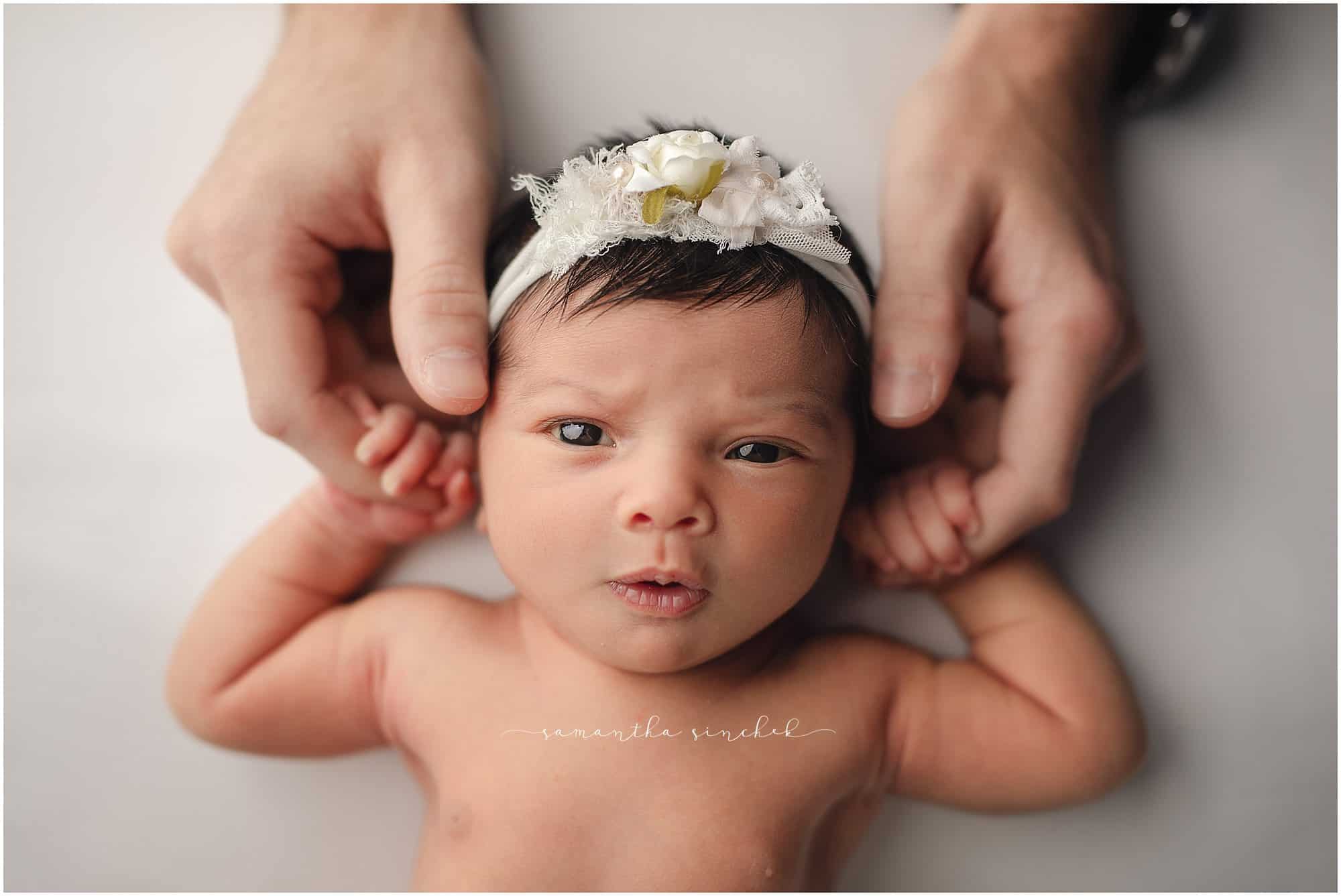 newborn baby girl holding parents hands at newborn pictures with Sinchek Photography of Cincinnati Ohio