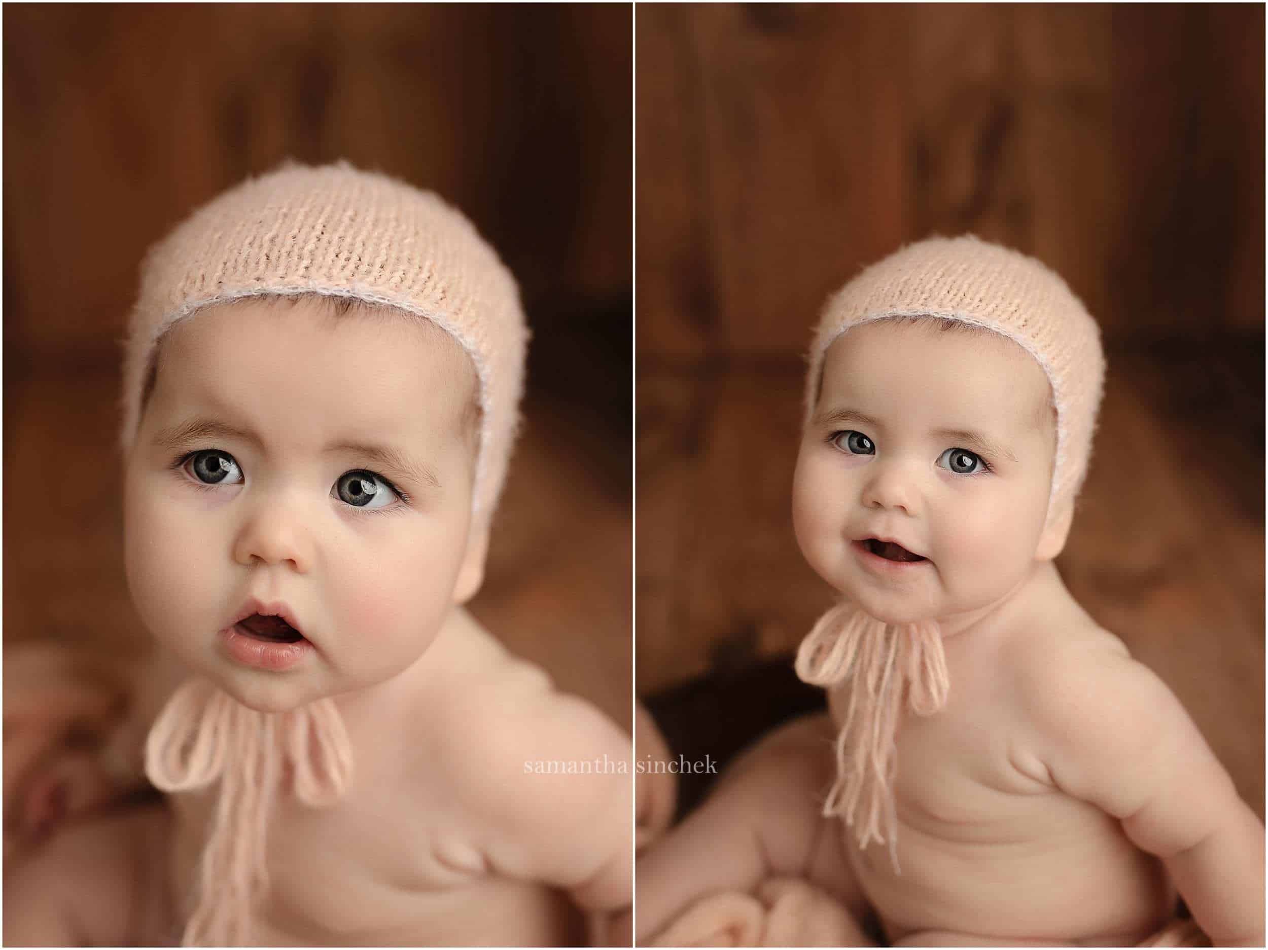 little girl sits in wood bowl wearing pink bonnet at photo session with Samantha Sinchek photography