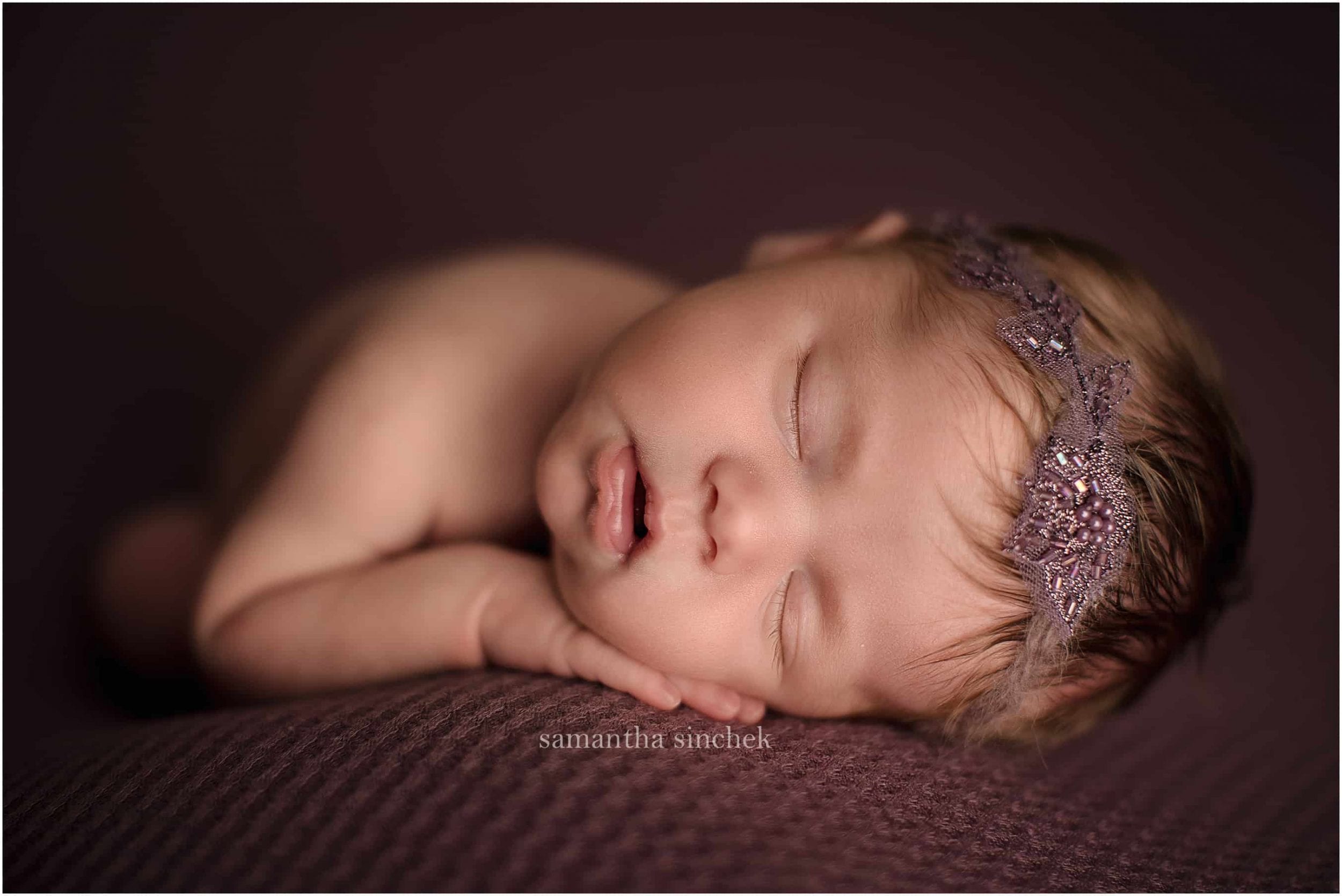 newborn girl sleeping wearing headband at Cincinnati Ohio newborn photographer sinchek