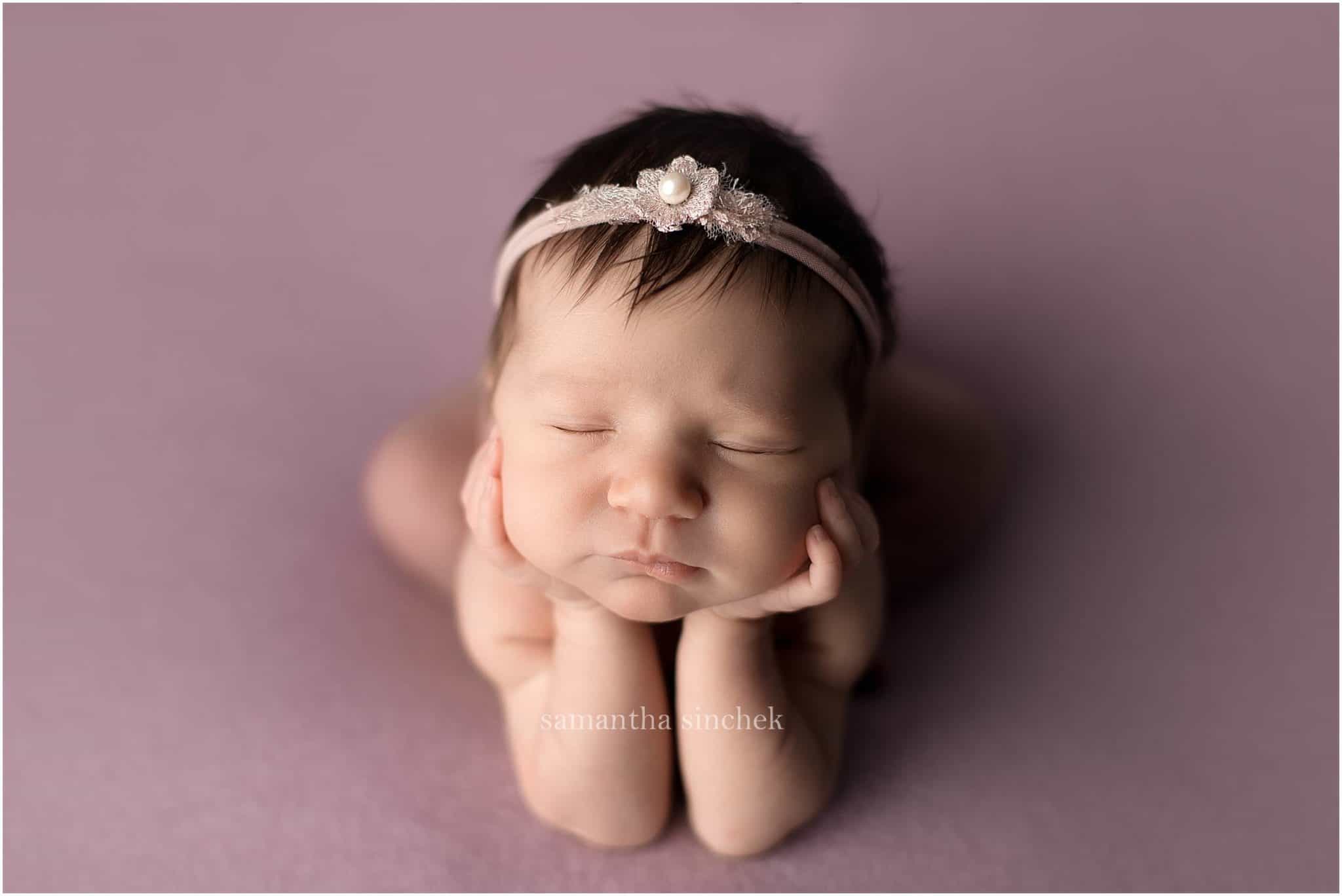 baby girl asleep on purple background with cincinnati newborn photographer Samantha Sinchek