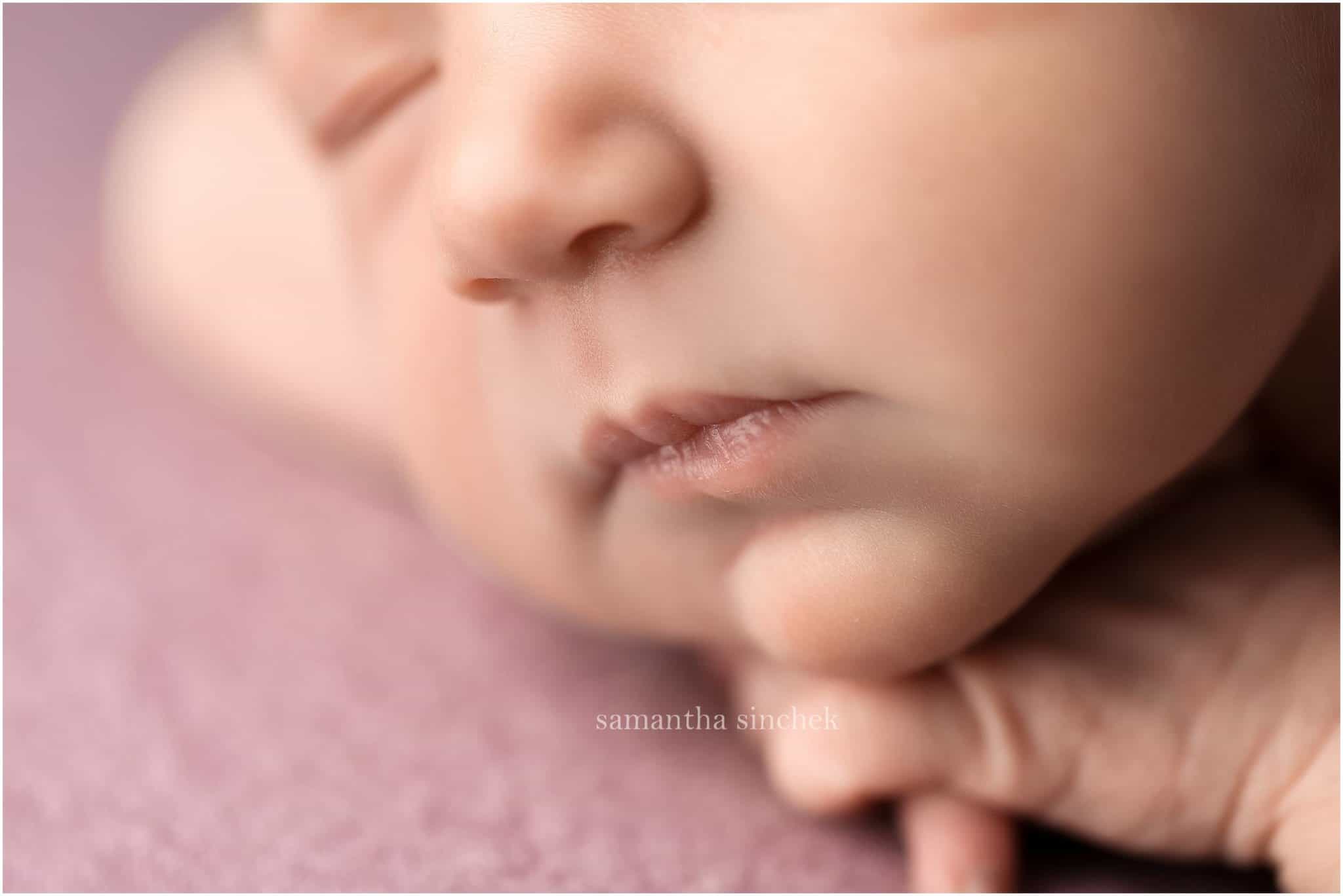 baby girl asleep on purple background with cincinnati newborn photographer Samantha Sinchek