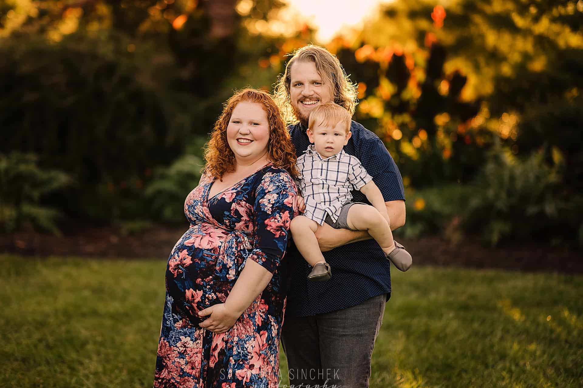 young family with pregnant mom poses during sunset with Cincinnati's best photographer